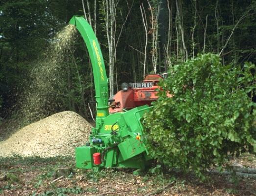 Broyeur Super-Pain 900 attelé sur tracteur, avec rouleaux ameneurs hydrauliques, en chantier de broyage